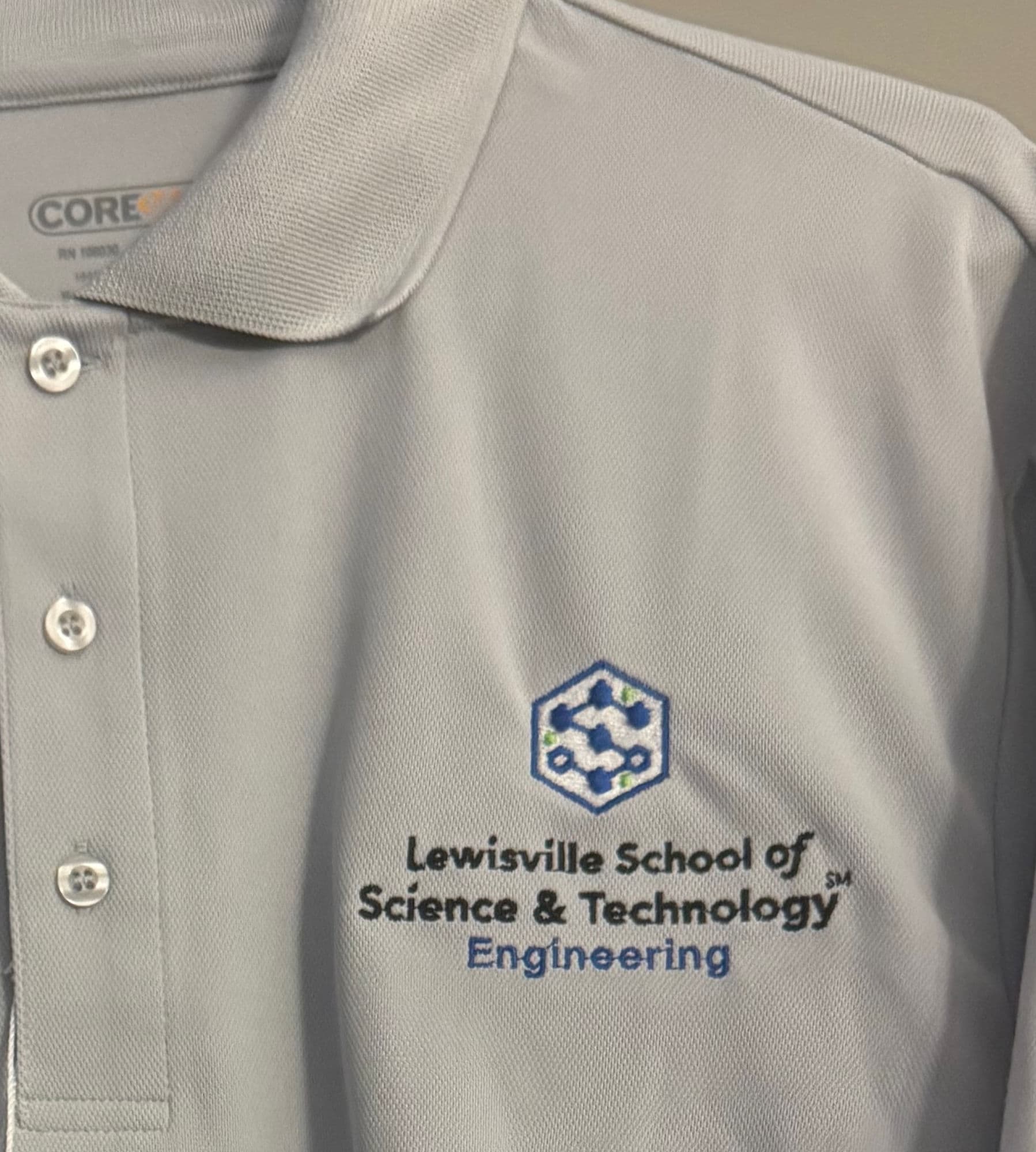Gray polo embroidered with the Lewisville School of Science & Technology Engineering logo